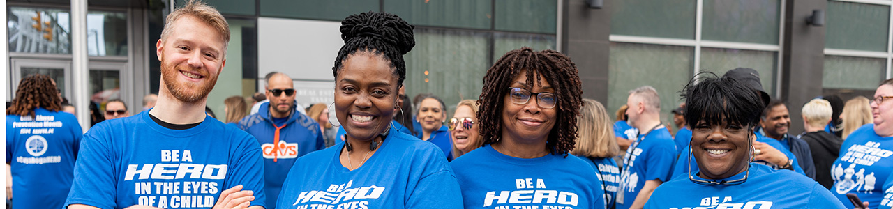 group of people wearing blue shirts that say Be a Hero