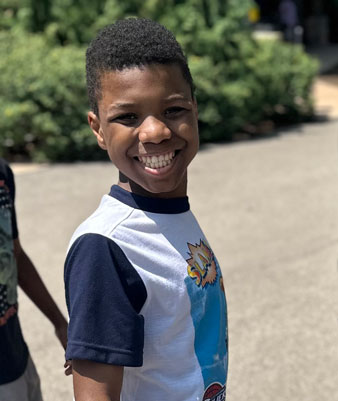 Young man standing outside.