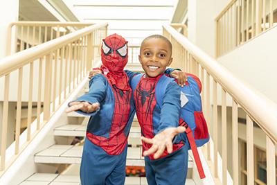 2 young boys dressed in Spider man Costume
