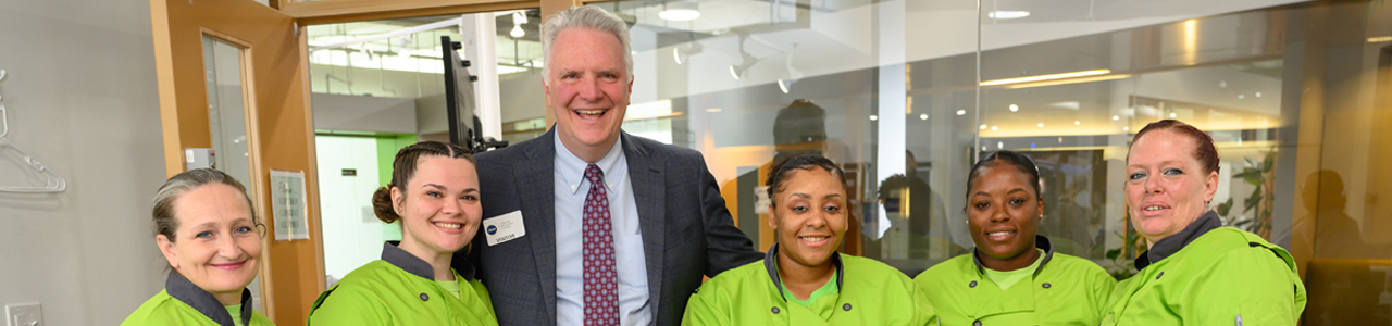 Chris Ronayne with Office of Reentry employees standing and smiling