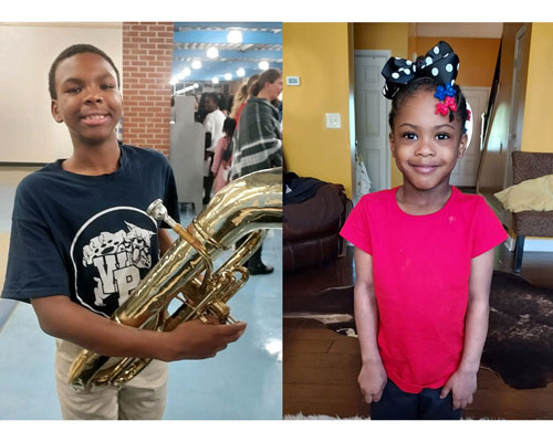 A young man holding a tuba and young girl wearing a cute bow.