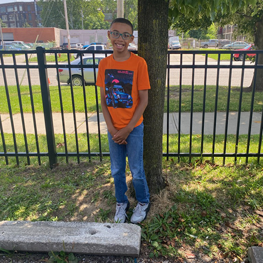 young man standing outside and smiling