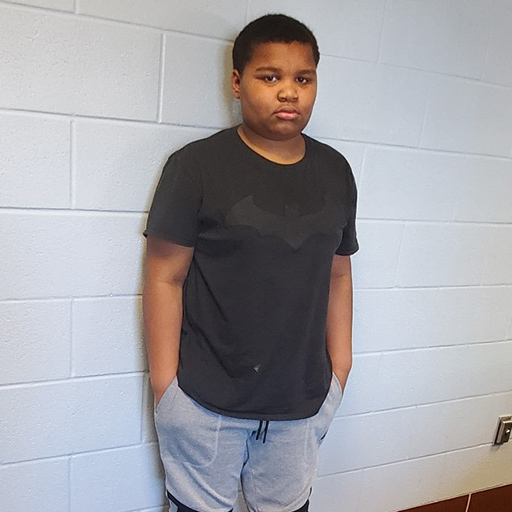 young man standing against a wall