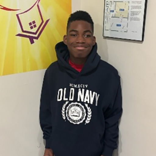 young man standing in a room and smiling