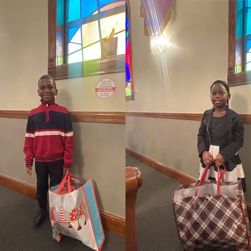 brother and sister holding Christmas bags