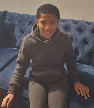 Young man sitting on a couch.