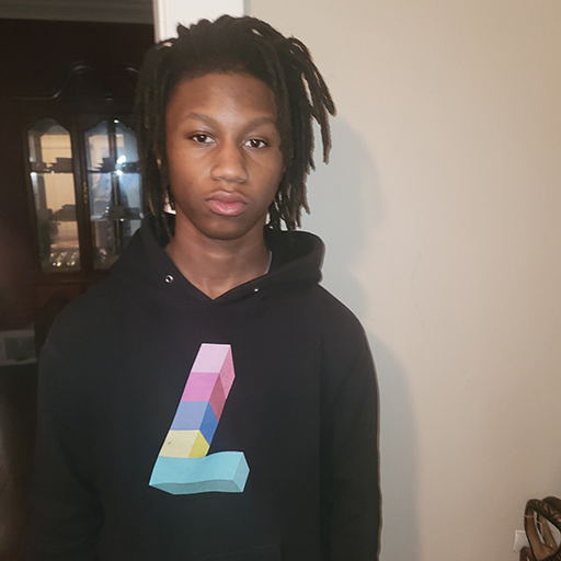 young man standing wearing a sweatshirt