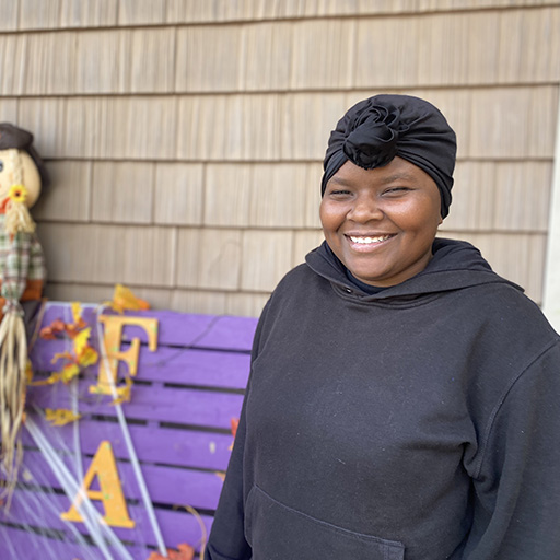 young woman standing outside and smiling