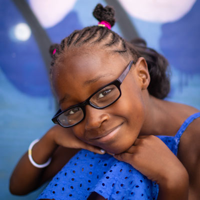 Young girl wearing glasses.