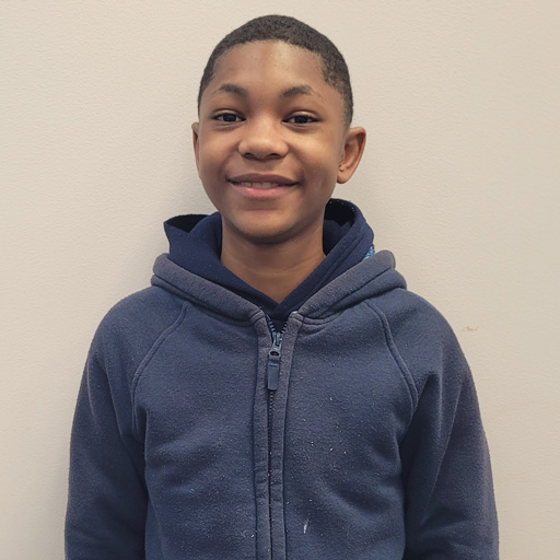 young man standing outside and smiling