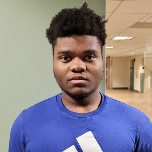 A young man wearing a blue shirt.