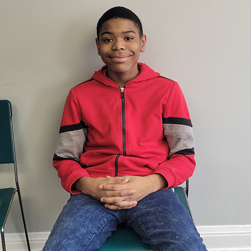 young man sitting and smiling